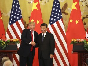 FILE - In this Nov. 9, 2017, file photo, U.S. President Donald Trump and Chinese President Xi Jinping shakes hands during a news conference at the Great Hall of the People in Beijing. Trump's trade battle with China will exacerbate relations with Beijing that are already fraying on several fronts as the U.S. takes a more confrontational stance and an increasingly powerful China stands its ground.