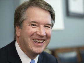 In this July 18, 2018, photo, Supreme Court nominee Judge Brett Kavanaugh smiles during a meeting with Sen. Mike Lee, R-Utah, a member of the Judiciary Committee, on Capitol Hill in Washington. Gay-rights supporters worry that Kavanaugh would take a more limited view of gay rights than the man he would replace, Justice Anthony Kennedy, who has written the court's major gay-rights rulings.