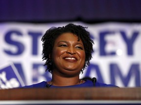 FILE - In this May 22, 2018, file photo, Democratic candidate for Georgia Governor Stacey Abrams smiles as she speaks during an election-night watch party in Atlanta. Democrats have long pointed to a Georgia electorate that is increasingly urban and less white as a sign they may be able to break the Republican hold on statewide offices. This year, after previous disappointments, they have a historic candidate for governor with enough star power to raise their hopes of an upset again. Abrams is a 44-year-old lawyer and former state legislative leader who is vying to become the first black woman in American history to be elected governor of any state.