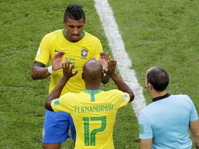 Brazil's Paulinho, top, leaves the pitch as being substituted for teammate Brazil's Fernandinho during the round of 16 match between Brazil and Mexico at the 2018 soccer World Cup in the Samara Arena, in Samara, Russia, Monday, July 2, 2018.