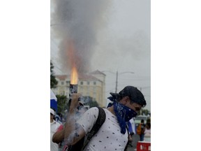 An university student fires a home made mortar during the commemoration of Student Day in an anti-government march demanding the ouster of President Daniel Ortega and the release of political prisoners, in Managua, Nicaragua, Monday, July 23, 2018. Anti-government protests began in mid-April over cuts to the social security system but broadened to include demands for Ortega to leave office and early elections to be held.