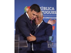 Spain's Prime Minister Pedro Sanchez, left, and his Portuguese counterpart Antonio Costa embrace at the end of a news conference following their meeting Monday, July 2 2018, in Lisbon.