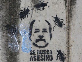 A graffiti depicting Nicaragua's President Daniel Ortega is seen on a wall while demonstrators gather to commemorate the 100 days of anti-government protests demanding the resignation of President Daniel Ortega and the release of all political prisoners, in Managua, Nicaragua, Thursday, July 26, 2018. A rights group on Thursday raised by nearly 100 to 448 the number of dead from more than three months of political upheaval and protests demanding that Ortega leaves office. The text on the wall reads in Spanish "Wanted, Murderer."