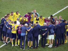 The Swedish team gathers together on the pitch at the end of the quarterfinal match between Sweden and England at the 2018 soccer World Cup in the Samara Arena, in Samara, Russia, Saturday, July 7, 2018.