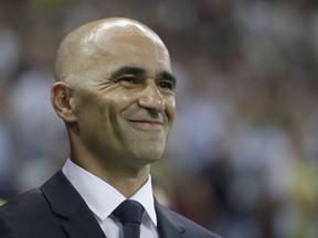 Belgium coach Roberto Martinez smiles as he waits for the start of the quarterfinal match between Brazil and Belgium at the 2018 soccer World Cup in the Kazan Arena, in Kazan, Russia, Friday, July 6, 2018.