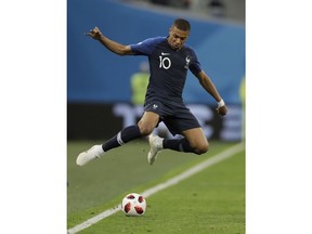 France's Kylian Mbappe leaps over the ball during the semifinal match between France and Belgium at the 2018 soccer World Cup in the St. Petersburg Stadium in, St. Petersburg, Russia, Tuesday, July 10, 2018.