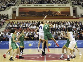 In this July 4, 2018, photo, South and North Korean players of Team Peace, in white, and Team Prosperity play during a friendly basketball game at Ryugyong Jong Ju Yong Gymnasium in Pyongyang, North Korea. (Korea Pool via AP)