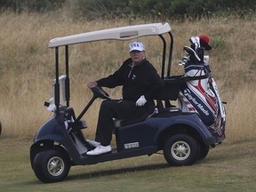 U.S. President Donald Trump drives a golf buggy on his golf course at Turnberry golf club, in Turnberry, Scotland, Sunday, July 15, 2018. President Trump and the First Lady spent the weekend in Scotland, as part of their visit to the UK before leaving for Finland where he will meet Russian leader Vladimir Putin for talks on Monday.