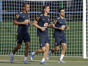 Brazil's Miranda, left, Filipe Luis, center, and Fagner jog during a training session, in Sochi, Russia, Friday, June 29, 2018. Brazil will face Mexico on July 2 in the round of 16 for the soccer World Cup.