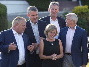 Ontario Premier Doug Ford, left to right, Nova Scotia Premier Stephen McNeil, Alberta Premier Rachel Notley, Manitoba Premier Brian Pallister and Newfoundland and Labrador Premier Dwight Ball chat as they wait for the official photo at the meeting of Canadian premiers in St. Andrews, N.B., on Wednesday, July 18, 2018.