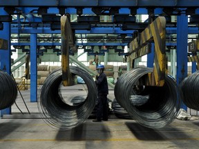 In this June 8, 2018, photo, a worker transfers steel cables at a steel factory in Qingdao in east China's Shandong province. The Trump administration on Monday, July 16, 2018, brought cases against China, the European Union, Canada, Mexico and Turkey at the World Trade Organization for retaliating against American tariffs on imported steel and aluminum. (Chinatopix via AP)