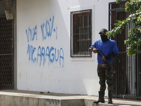 An armed pro-government militia occupies the Monimbo neighborhood of Masaya, Nicaragua, Wednesday, July 18, 2018. On Tuesday, Nicaraguan government forces retook the symbolically important neighborhood that had recently become a center of resistance to Ortega's government.