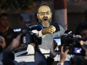 FILE - In this March 13, 2018 file photo, Ziad Itani, a Lebanese stage actor, who was indicted on charges of collaborating with Israel and drug possession, shouts as he speaks with journalists after he was released by Lebanese authorities, at his house, in Beirut, Lebanon. The New York-based Human Rights Watch called on Lebanese authorities to investigate allegations of torture made by Itani. The watchdog said Monday, July 16, 2018, that the case of Itani is a test for whether the law criminalizing torture, passed in November, will end impunity for security officials.