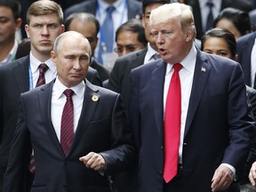 FILE - This Saturday, Nov. 11, 2017 file photo, shows U.S. President Donald Trump and Russia's President Vladimir Putin talking during the family photo session at the APEC Summit in Danang, Vietnam. When Trump meets Putin on Monday, July 16, 2018, the Syrian conflict will be the most immediately pressing issue on a wide-ranging agenda.