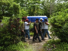 Friends and family carry the coffin with the body of Jose Esteban Sevilla Medina, who died after he was shot in the chest at a barricade during an attack by the police and paramilitary forces, in Masaya, Nicaragua, Monday, July 16, 2018. Tensions in Nicaragua erupted this spring after the government announced cuts to social security but then widened into a call for President Daniel Ortega to leave power. The crisis has left around 270 dead and more than 2,000 wounded as forces loyal to the government crack down on opponents.