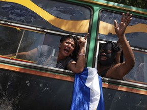 Students who had taken refuge at the Jesus of Divine Mercy church amid a barrage of armed attacks, arrive on a bus to the Metropolitan cathedral, in Managua, Nicaragua, Saturday, July 14, 2018. Cardinal Leopoldo Brenes negotiated for the safe transfer of students. The students had sought refuge in a local church after police forced them out of the National Autonomous University of Nicaragua, which had been occupied during two months of protests against the government of President Daniel Ortega.