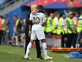 France head coach Didier Deschamps, embraces France's Kylian Mbappe after he was replaced during the quarterfinal match between Uruguay and France at the 2018 soccer World Cup in the Nizhny Novgorod Stadium, in Nizhny Novgorod, Russia, Friday, July 6, 2018.