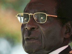 FILE - In this Friday, April, 18, 2008 file photo the then Zimbabwean President, Robert Mugabe, waits to deliver his speech during the 28th Independence Celebrations in Harare. Mugabe won't be on the ballot when elections are held on July 30, 2018, but the military-backed system that kept him in power for decades, and then pushed him out, is still in control.