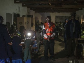 The last of the voters cast their ballots at a polling station near Harare, Zimbabwe, Monday July 30, 2018 . Polls have closed in Zimbabwe's historic election, the first since the fall of longtime leader Robert Mugabe. Millions have voted, turnout was high and the day was free of the violence that marked previous elections.