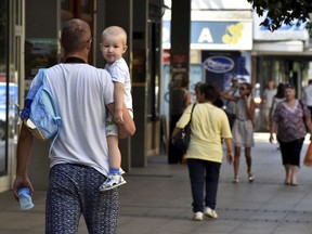 People walk trough the street in Montenegro's capital Podgorica, Thursday, July 19, 2018.  U.S. President Donald Trump  suggested Montenegro may start World War III, but the government on Thursday issued a statement saying it was proud of the country's "history and tradition and peaceful politics".