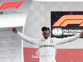 Mercedes driver Lewis Hamilton of Britain celebrates on the podium after winning the German Formula One Grand Prix at the Hockenheimring racetrack in Hockenheim, Germany, Sunday, July 22, 2018.
