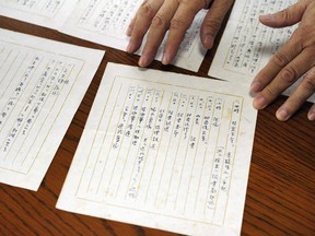 In this July 26, 2018, photo, Takeo Hatano, a used bookstore owner, shows the five-page "Yuzawa memo," written by Michio Yuzawa, interior vice minister in 194, in Tokyo. The newly released memo by a wartime Japanese official provides what a historian says is the first look at the thinking of Emperor Hirohito and Prime Minister Hideki Tojo on the eve of the Japanese attack on Pearl Harbor that thrust the U.S. into World War II.