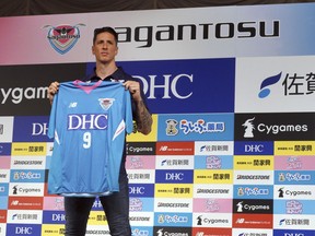 Fernando Torres poses with his uniform of Sagan Tosu during a press conference in Tokyo Sunday, July 15, 2018. Former Spain striker Torres signed to play for Sagan Tosu in the J1 League last week.