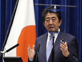 Japanese Prime Minister Shinzo Abe delivers a speech during a press conference at the prime minister's official residence in Tokyo Friday, July 20, 2018.