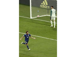 Japan's Takashi Inui, left, celebrates after scoring his second side goal during the round of 16 match between Belgium and Japan at the 2018 soccer World Cup in the Rostov Arena, in Rostov-on-Don, Russia, Monday, July 2, 2018.