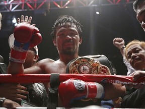 Manny Pacquiao of the Philippines poses after defeating Lucas Matthysse of Argentina during their WBA World welterweight title bout in Kuala Lumpur, Malaysia, Sunday, July 15, 2018. Pacquiao won the WBA welterweight world title after knocking out Matthysse on round seven.
