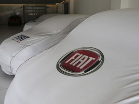 Cars are parked at a Fiat car dealership in Milan, Italy, Wednesday, July 25, 2018. Sergio Marchionne, a charismatic and demanding CEO who engineered two long-shot corporate turnarounds to save both Fiat and Chrysler from near-certain failure, died Wednesday. He was 66. The holding company of Italian automaker Fiat's founders, the Agnelli family, announced Marchionne had died after complications from surgery in Zurich. At Fiat Chrysler Automobiles headquarters in the Italian town of Turin, flags flew at half-mast, while in Rome the parliamentary committee for labor and finance observed a minute of silence.