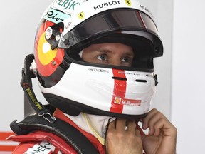 Ferrari driver Sebastian Vettel of Germany prepares at pit during the first free practice at the Hockenheimring racetrack in Hockenheim, Germany, Friday, July 20, 2018. The German Formula One Grand Prix will be held on Sunday, July 22, 2018.