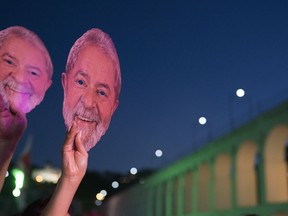 People hold up masks depicting the Brazilian former president Luiz Inacio da Silva during the Lula Free festival in Rio de Janeiro, Brazil, Saturday, July 28, 2018. Popular Brazilian musicians and social movements organized a concert to call for the release of da Silva, who has been in prison since April, but continues to lead the preferences on the polls ahead of October's election.