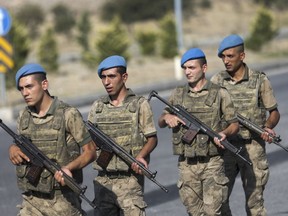 Members of Turkish forces patrol the perimeter of a prison complex in Aliaga, Izmir province, western Turkey, where jailed US pastor Andrew Craig Brunson is appearing for his trial at a court inside the complex, Wednesday, July 18, 2018. The 50-year-old evangelical pastor from Black Mountain, North Carolina, faces up 35 years in prison in Turkey on charges of "committing crimes on behalf of terror groups without being a member" and "espionage."