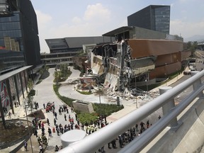 The Artz Pedregal shopping mall stands partially collapsed, on the south side of Mexico City, Thursday, July 12, 2018. The mall collapsed after structural problems apparently led the mall's operators to stage a quick, controlled demolition. The head of civil protection says there were injuries.