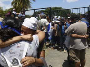 Students, who had taken refuge at the Jesus of Divine Mercy church amid a barrage of armed attacks, embrace relatives, in Managua, Nicaragua, Saturday, July 14, 2018. On Saturday morning, Cardinal Leopoldo Brenes negotiated with the president's office for the safe transfer of students out of the church and to the Metropolitan cathedral.