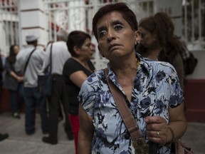 In this July 11, 2018 photo, Olga Hernandez, who recently lost her sight, stands outside of Mexico's President-elect Andres Manuel Lopez Obrador's headquarters in the Roma neighborhood of Mexico City. Hernandez delivered a letter to the President-elect requesting that she again receive a pension for seniors.