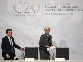 Christine Lagarde, right, International Monetary Fund Managing Director and Argentina Treasury Minister Nicolas Dujovne arrives for a press conference during the G20 meeting of Finance Ministers and Central Bank governors in Buenos Aires, Argentina, Saturday, July 21, 2018.