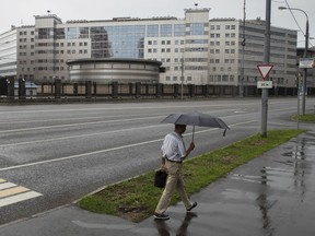 A man walks past the building of the Russian military intelligence service in Moscow, Russia, Saturday, July 14, 2018. U.S. President Donald Trump on Saturday scolded the Obama administration for not responding aggressively enough to Russian hacking of Democratic targets in the 2016 U.S. election -- cyberattacks underpinning the indictment of 12 Russian military intelligence officers. Trump's first response to special counsel Robert Mueller's initial charges against Russian government officials for interfering in American politics came in tweets the president posted while at his golf resort in Scotland, two days before a high-stakes summit in Finland with Russian leader Vladimir Putin.