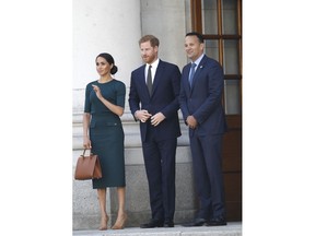 Britain's Prince Harry and Meghan Duchess of Sussex meet with the Irish Prime Minister Leo Varadkar, right, at government buildings in Dublin, Ireland, Tuesday, July 10, 2018. The Royal couple arrived in the Irish capital for a two day visit.