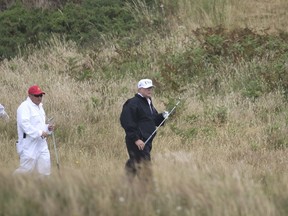 U.S. President Donald Trump plays golf at Turnberry golf club, Scotland, Saturday, July 14, 2018. Trump is spending the weekend at his sea-side Trump Turnberry golf resort in Scotland, where aides had said he would be busy preparing for his Monday summit in Helsinki, Finland.