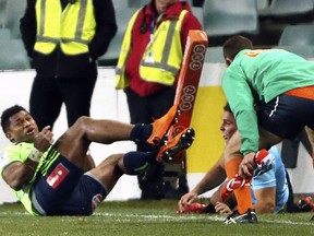 Highlanders' Waisake Naholo, left, scores a try despite the effort of Waratahs' Nick Phipps, second right, during their Super Rugby quarterfinal match in Sydney, Saturday, July 21, 2018.