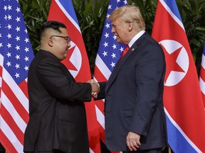 In this June 12, 2018, file photo, U.S. President Donald Trump, right, shakes hands with North Korean leader Kim Jong Un at the Capella resort on Sentosa Island in Singapore.