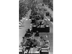 FILE - In this May 29, 1980 file photo, South Korean army tanks withdraw from downtown Gwangju, South Korea, to the outskirts of town after government troops recaptured the city the day before. Military interventions in South Korea have been nonexistent since the country achieved democracy in the late 1980s. But revelations this past week of a document showing the military drafted plans to mobilize troops to suppress protests last year have struck a nerve among people in one of Asia's most vibrant and wealthiest democracies. Some allege the plans even included a scenario for a coup.(AP Photo, File)