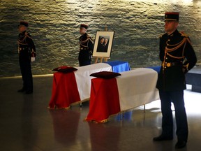 The flag-draped coffins of French politician Simone Veil, right, and her husband Antoine Veil are displayed at  the French Holocaust memorial in Paris, Friday, June 29, 2018. A year after the death of Simone Veil, the guarded casket of the Holocaust survivor who became one of France's most revered politicians, lies at the Holocaust Memorial in Paris, along with that of husband Antoine, so the public can pay homage ahead of the couple's burial on Sunday at the Pantheon, where French heroes are interred.