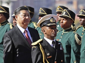 President Xi Jinping of China, left, inspect the honour guard during an official welcoming ceremony at the government's Union Buildings, in South Africa, Tuesday, July 24, 2018. Jinping is in the country to attend the three-day BRICS Summit starting Wednesday in Johannesburg.