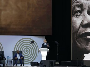 U.S. President Barack Obama, at podium delivers his speech at the 16th Annual Nelson Mandela Lecture at the Wanderers Stadium in Johannesburg, South Africa, Tuesday, July 17, 2018. In his highest-profile speech since leaving office, Obama urged people around the world to respect human rights and other values under threat in an address marking the 100th anniversary of anti-apartheid leader Nelson Mandela's birth.