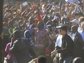 Nelson Chamisa, center, head of the MDC opposition alliance greets supporters at a rally in Chitungwiza about 30 kilometres east of the capital Harare, Thursday, July, 26, 2018. Chamisa addressed his first rally since rejecting the idea of boycotting elections on Monday despite what he calls a biased election commission, in the first election since the November resignation of longtime leader Robert Mugabe.