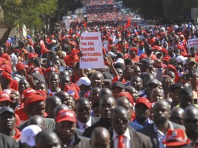 Thousands of opposition party supporters march on the streets of Harare, Wednesday, July 11, 2018. The world's oldest person is 141 years of age and lives in Zimbabwe. At least that's according to the country's voters' roll, which has come under sharp scrutiny ahead of the July 30 election, the first in decades without longtime leader Robert Mugabe. The main opposition party has called the voters' roll deeply flawed and the most prominent sign that the election's credibility is at risk. On Wednesday, thousands of people were rallying in the capital, Harare, to call for more transparency.
