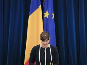 FILE- In this Thursday, Feb. 23, 2017 file photo, Romania's head of the anti-graft agency (DNA) Laura Codruta Kovesi finishes reading the unit's annual report in Bucharest, Romania. Romania's president Klaus Iohannis fired Kovesi Monday, July 9, 2018, over accusations of misconduct and incompetence.
